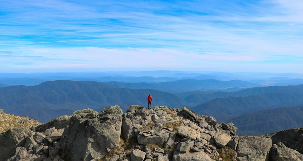 person standing on rock formation