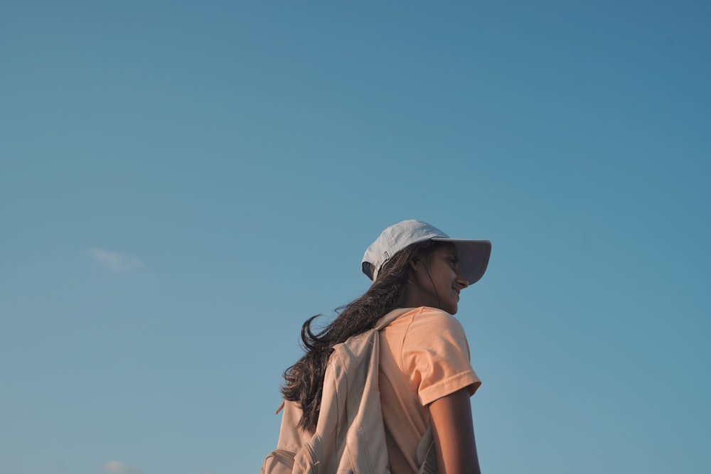 woman wearing cap under blue sky