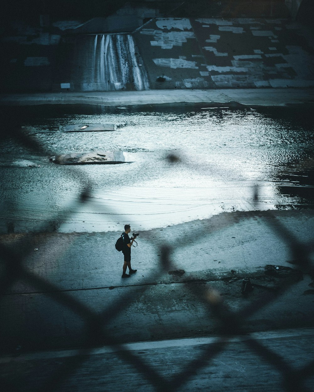 person walking near waterfalls