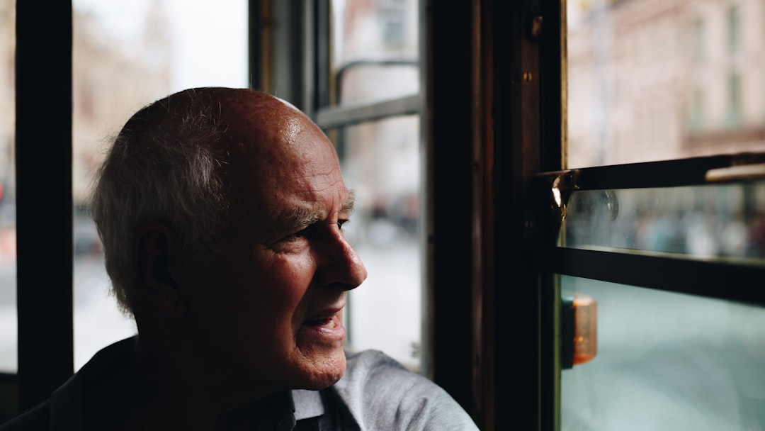 man near glass window