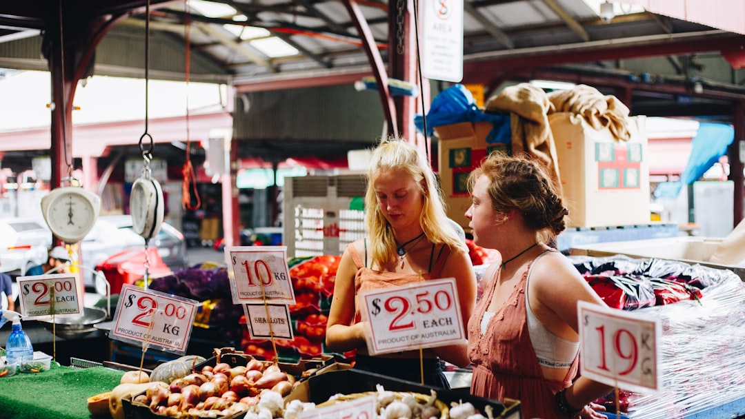 two women selling good at supermarket