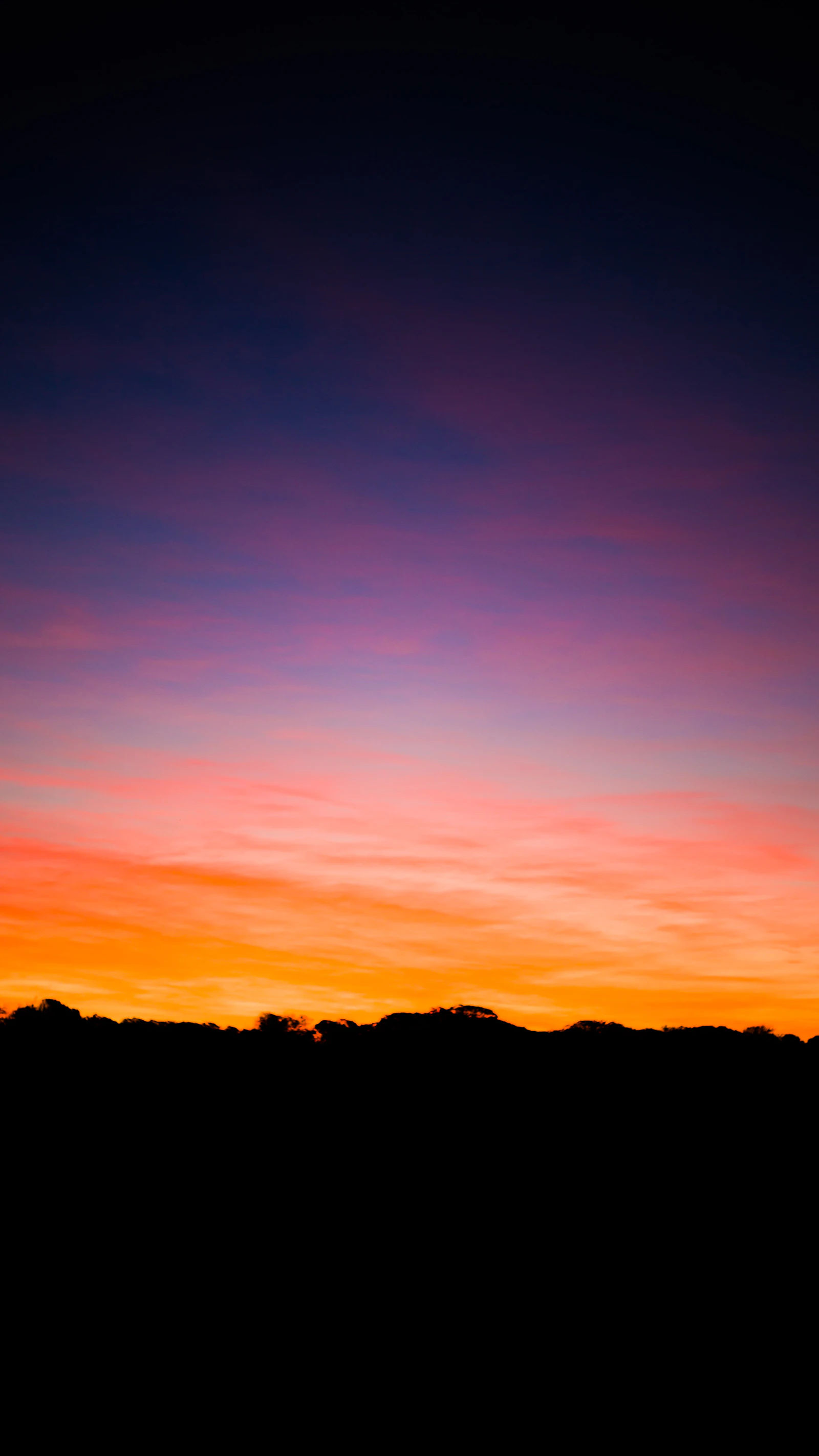 Aircraft silhouetted against a sunset sky