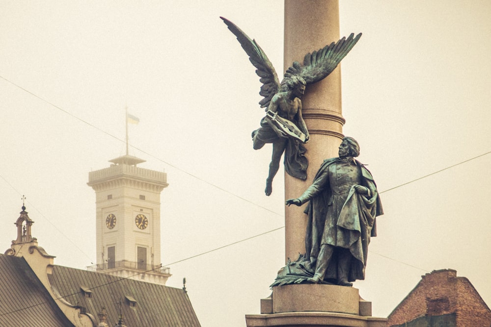 man standing near angel statue