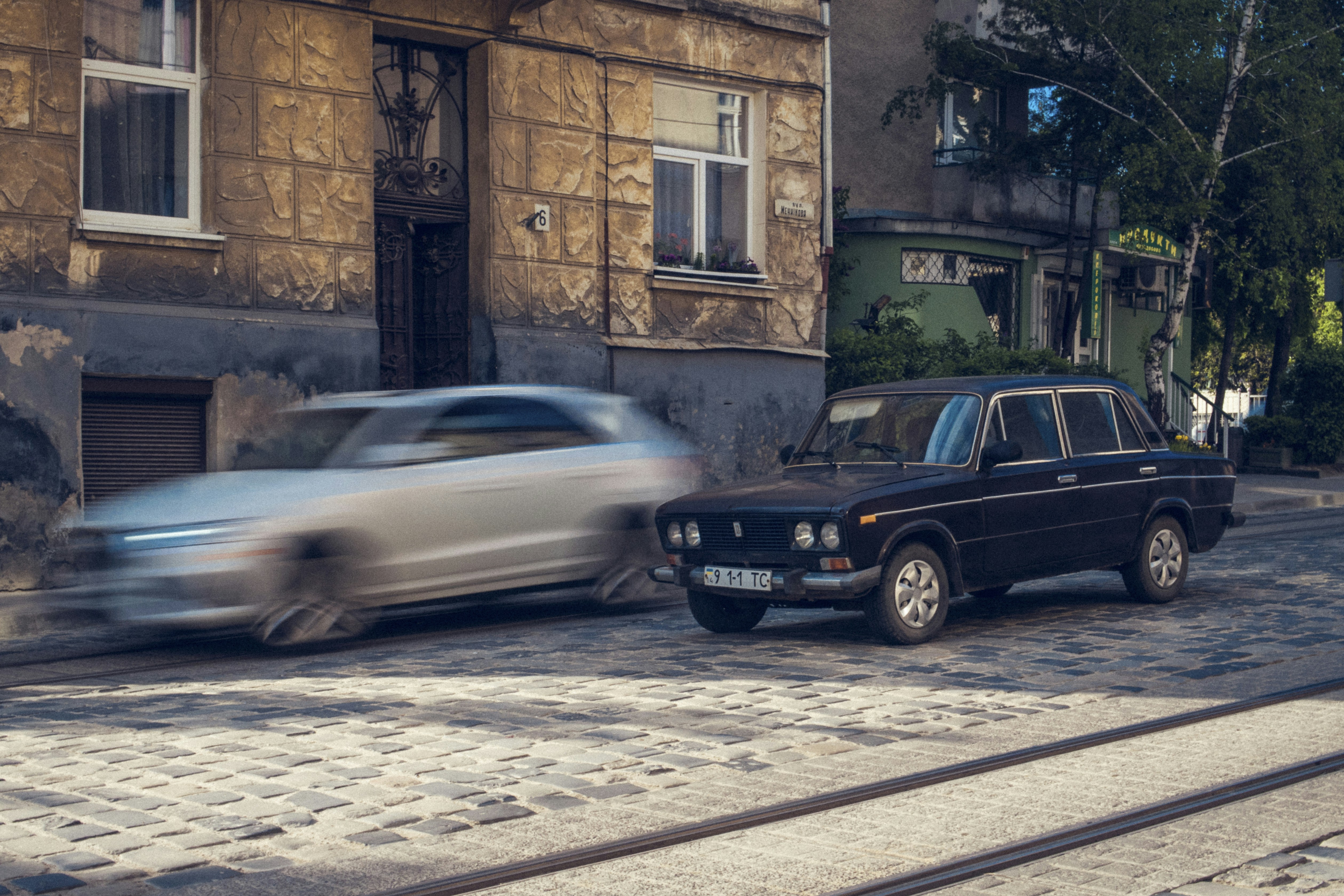 two black and silver vehicles on r oad