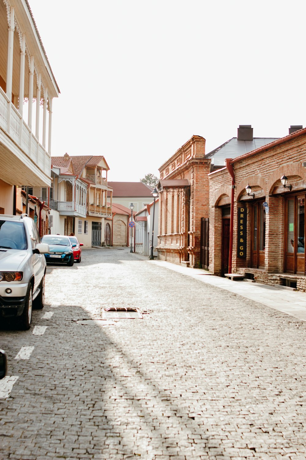 few vehicles parking near concrete buildings