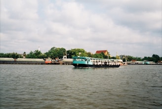 A sleek boat cruising on calm turquoise river waters