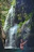 women under a waterfalls during daytime