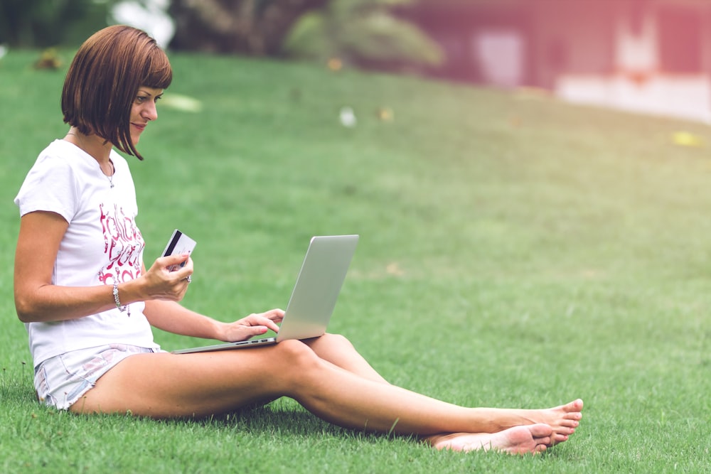 woman sitting on grass field