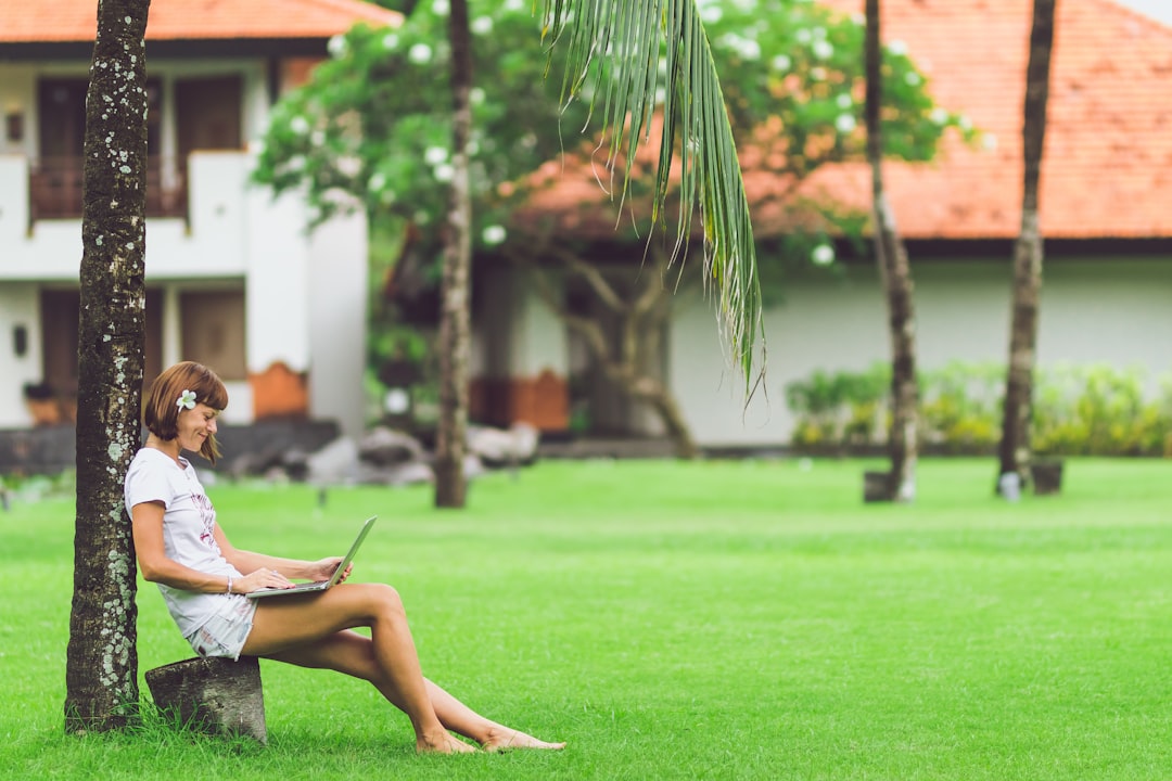 woman sitting under tree