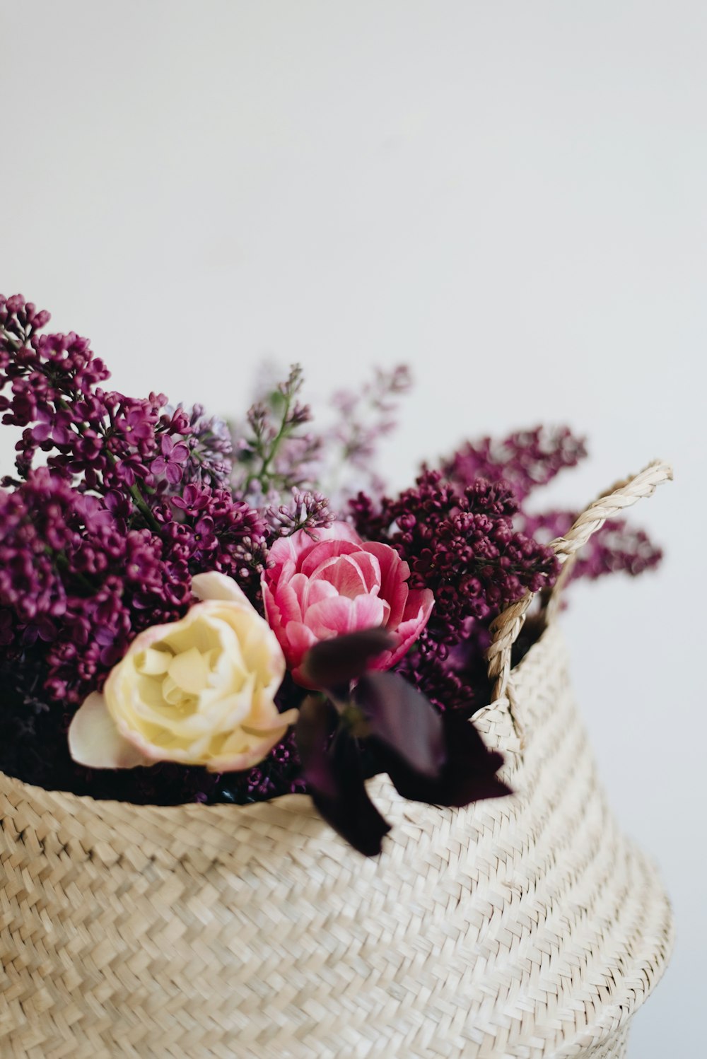 assorted flowers in brown wicker basket