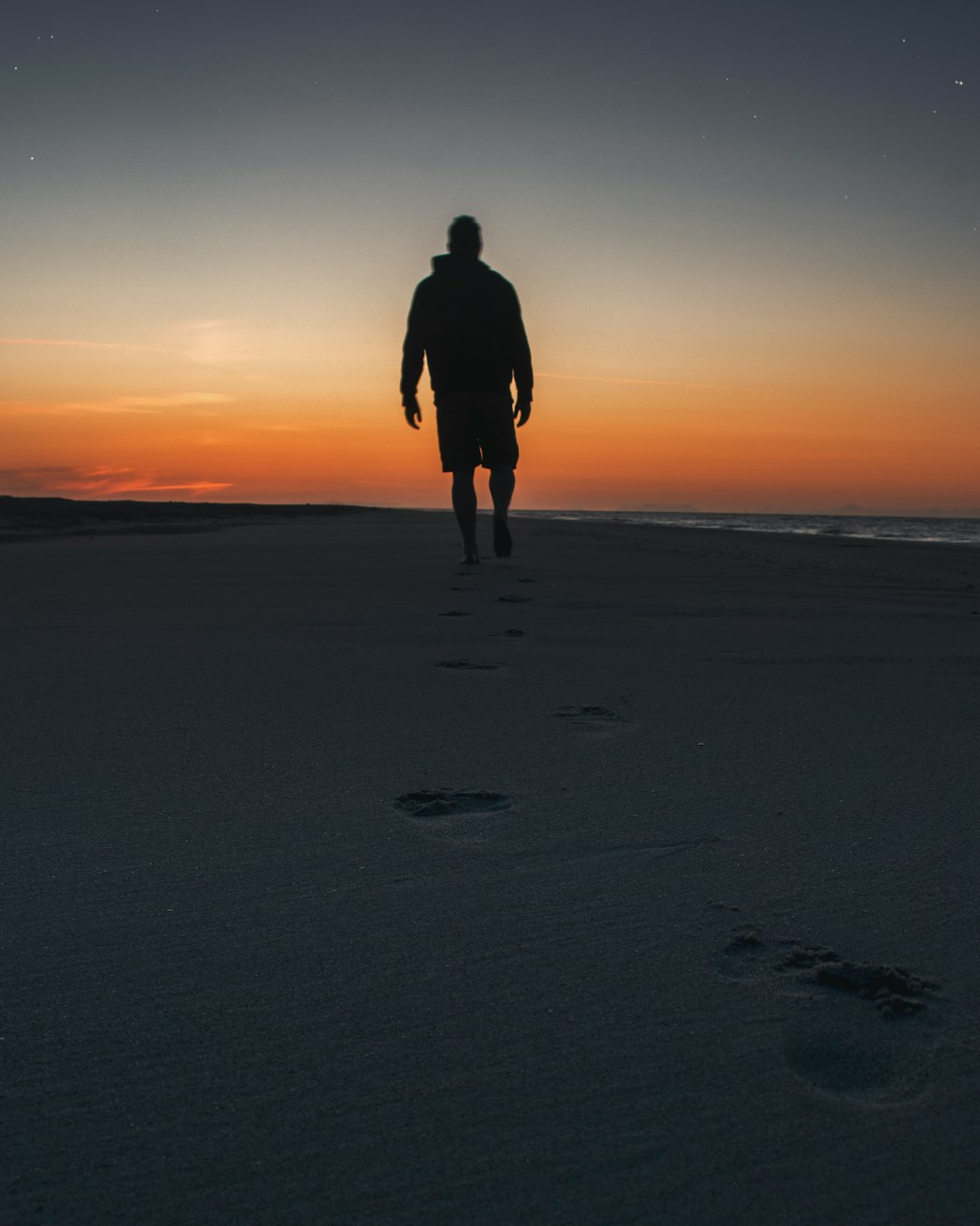 man walking on seashore