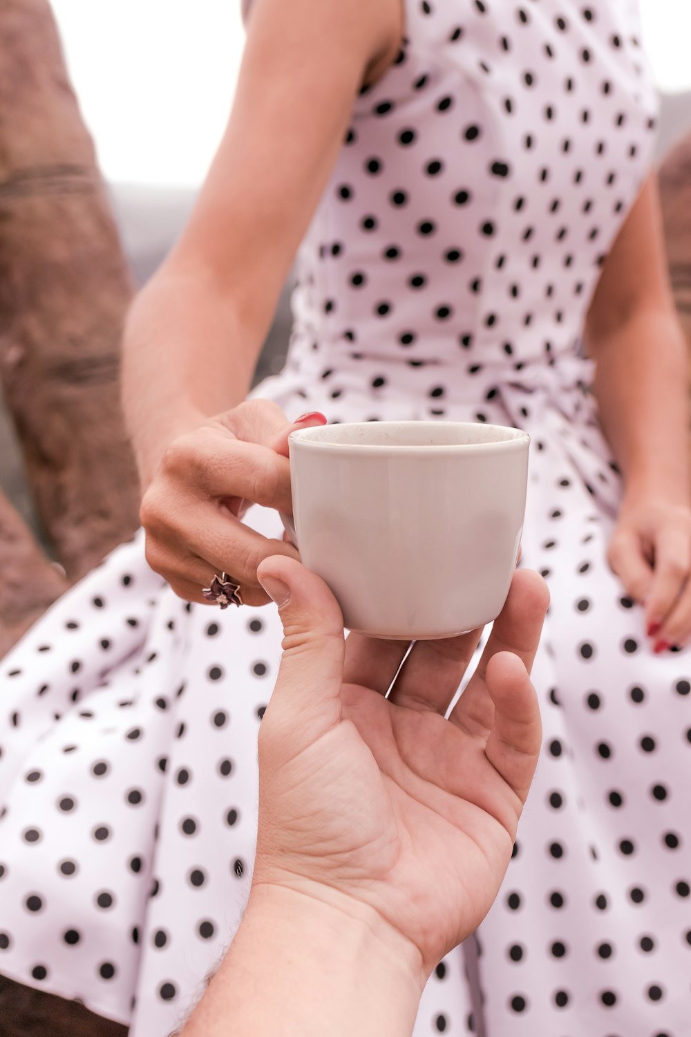 women;s white polka dot dress close-up photography