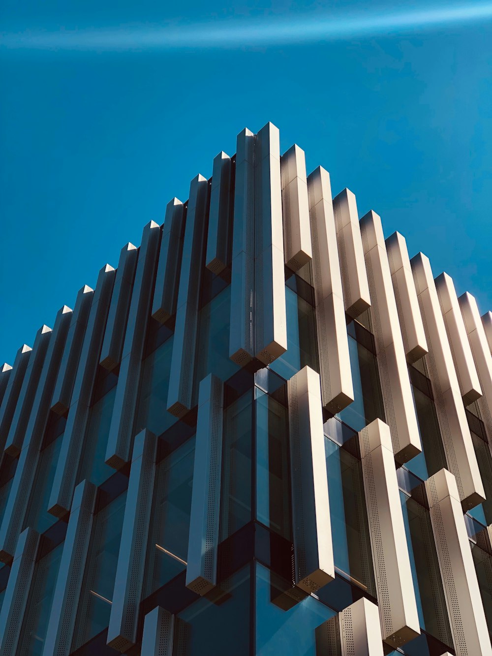 clear and gray building under blue sky during daytime close-up photography