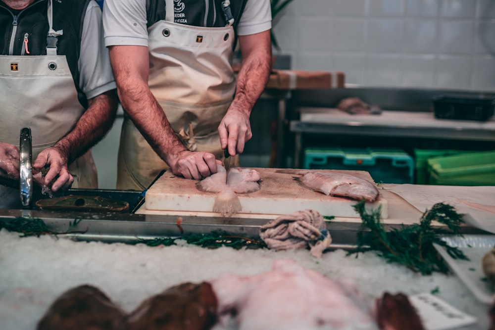 person slicing raw meat