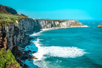 white rock cliff beside body of water' ireland google meet background