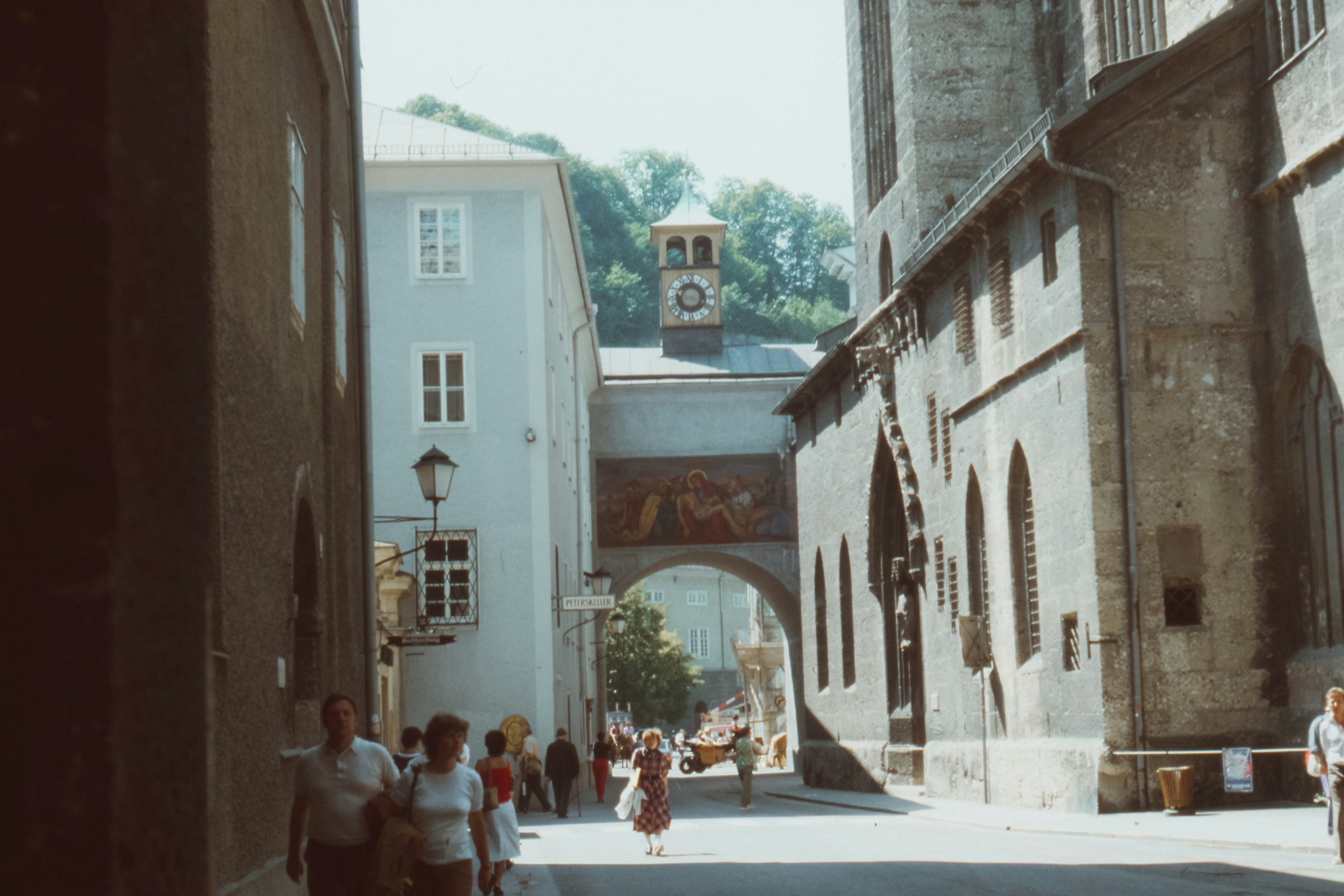 people walking on pathway surrounded by building