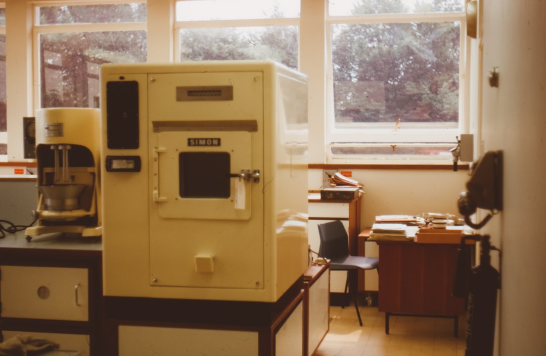 machine on table in front of windows