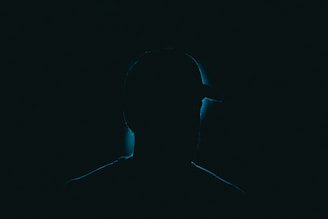 a silhouette of a person in the dark