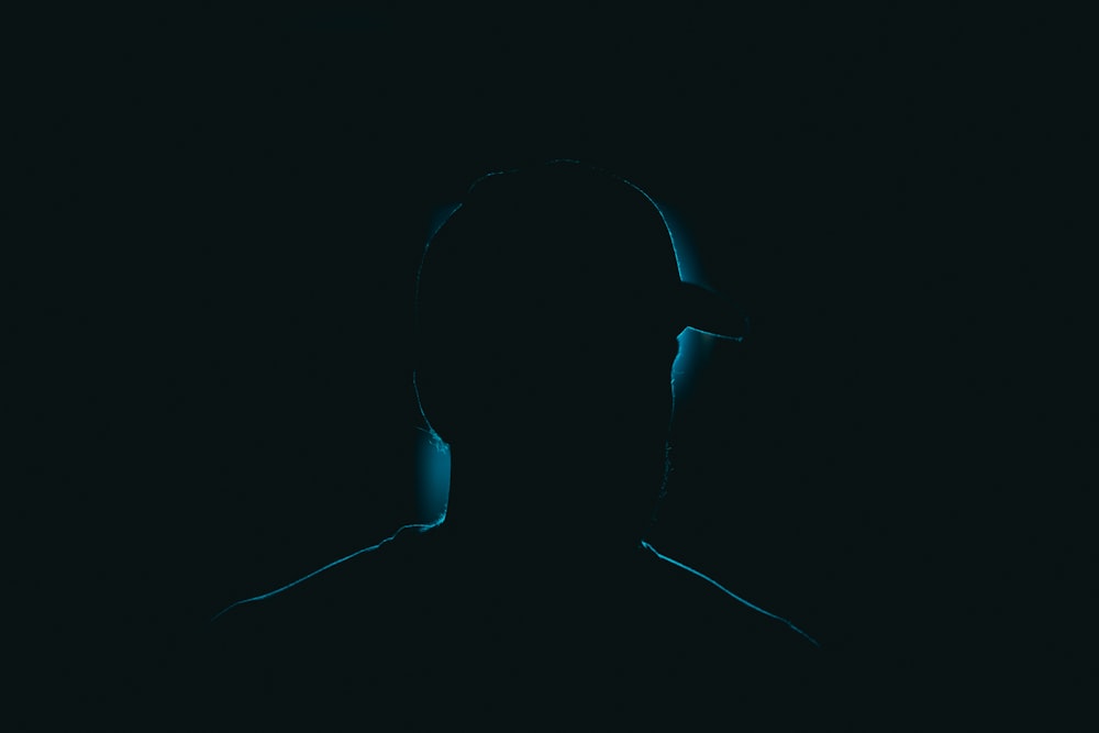 a silhouette of a person in the dark