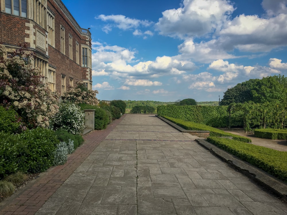 brick walkway near brown house