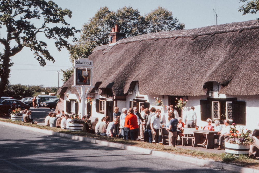 people gathered near house during daytime