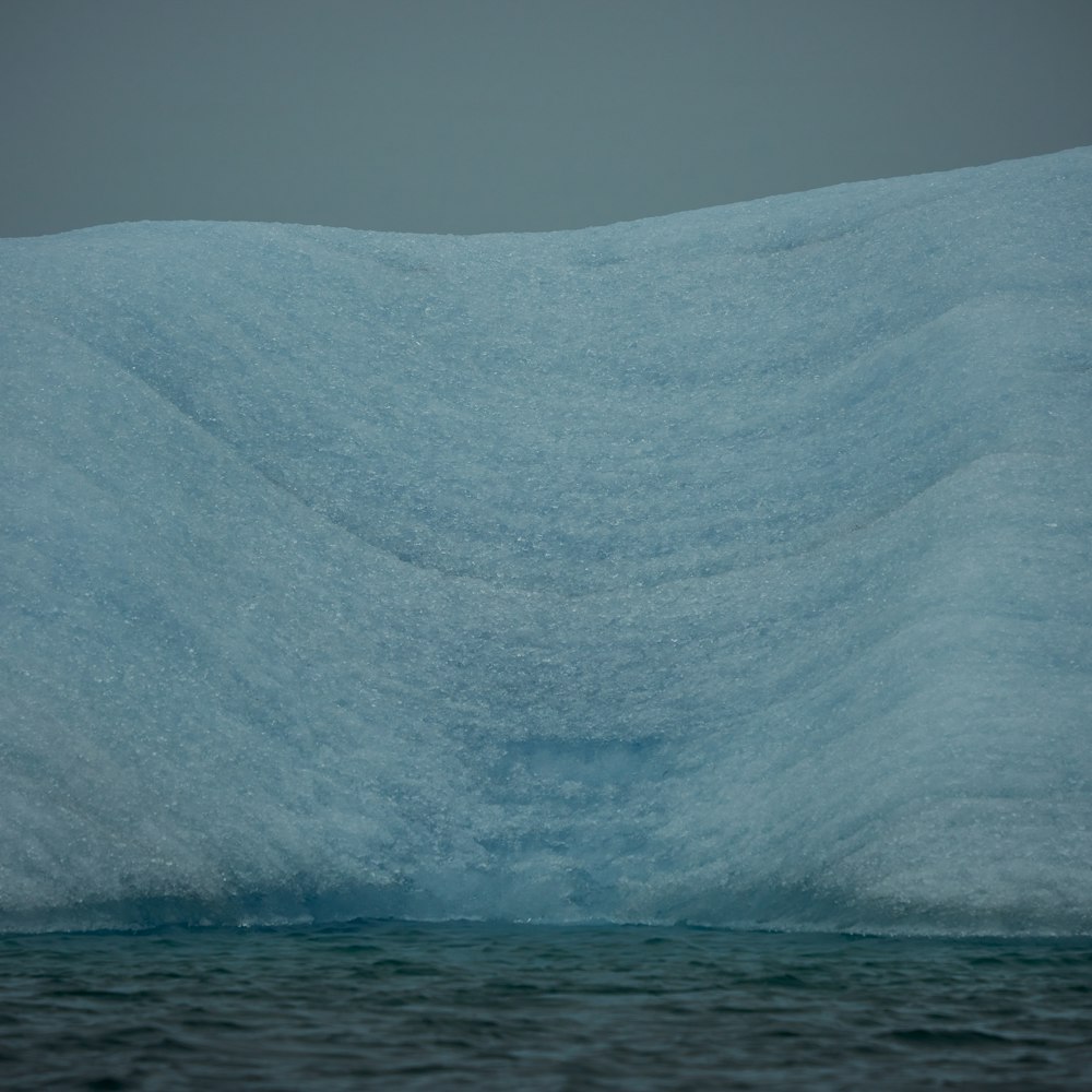 a large iceberg in the middle of the ocean