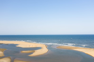 View of the beach from the suite, with calm waves and golden sand