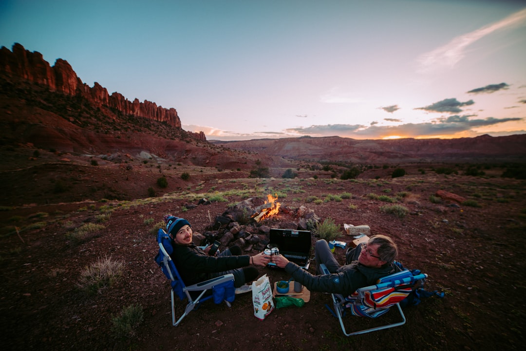 men sitting on hill, Dinner and a fire after driving one hour down a dirt road in southern Utah.