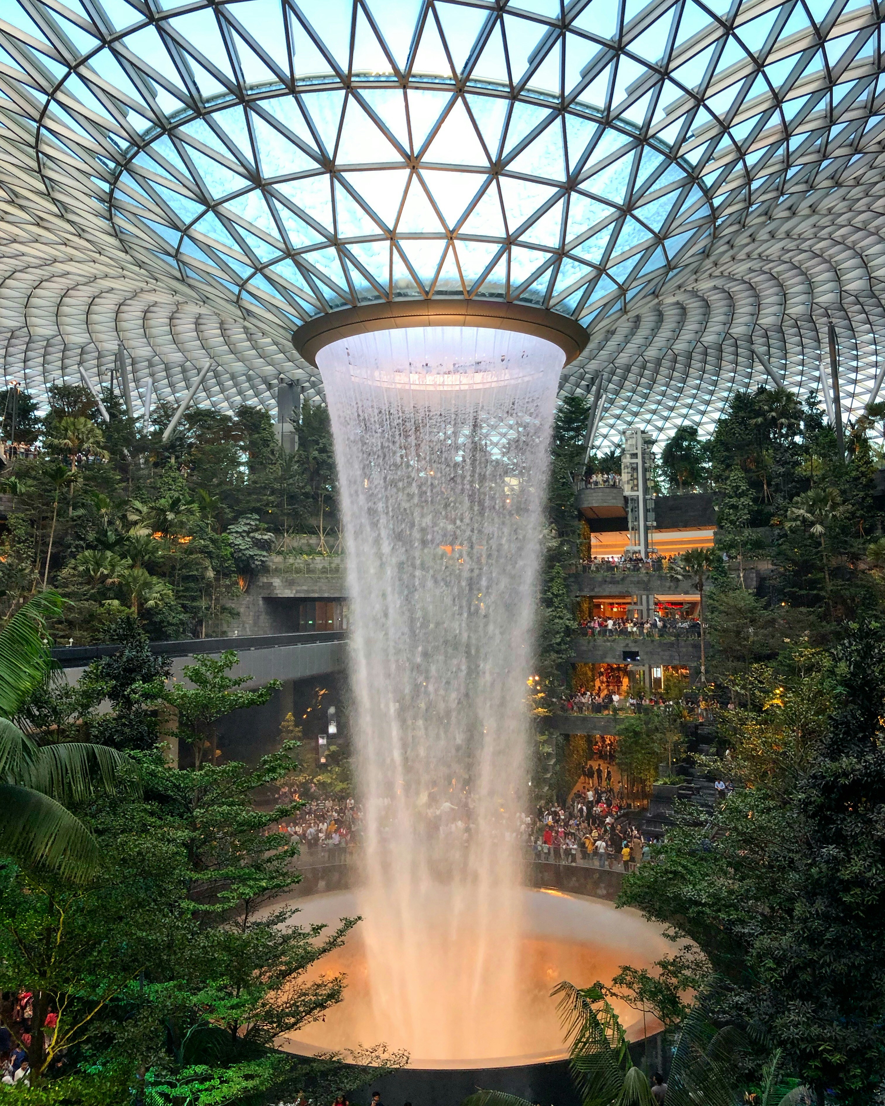 Water fountain surrounded by trees inside building photo – Free ...