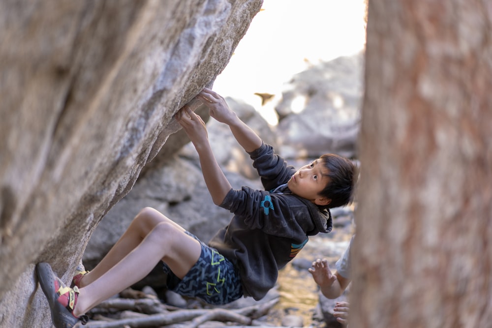 boy climbing on rocks