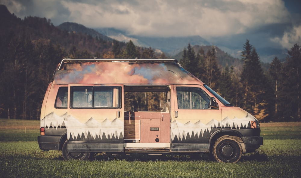 brown and black vehicle parked near trees