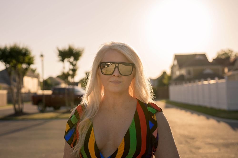 woman wearing multicolored top and black sunglasses