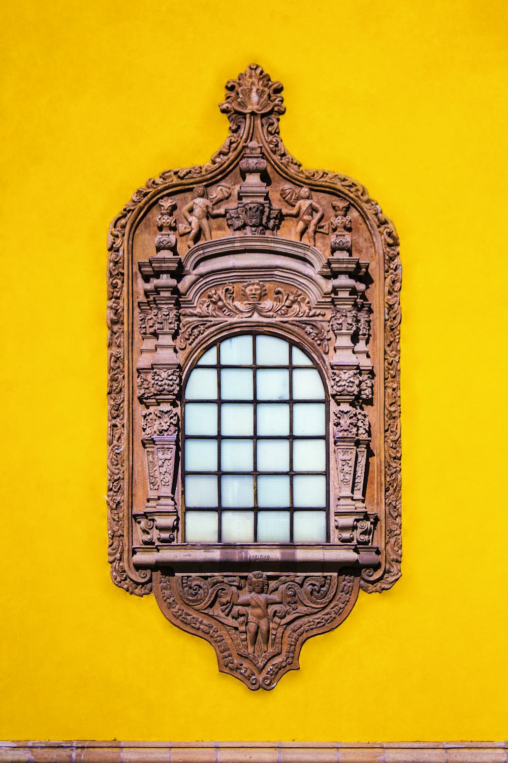 brown window on yellow wall