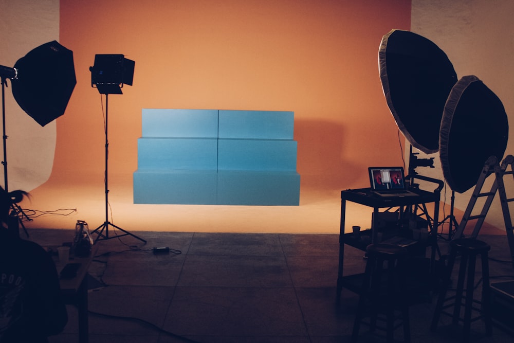 two blue wooden pedestals on stage with lights