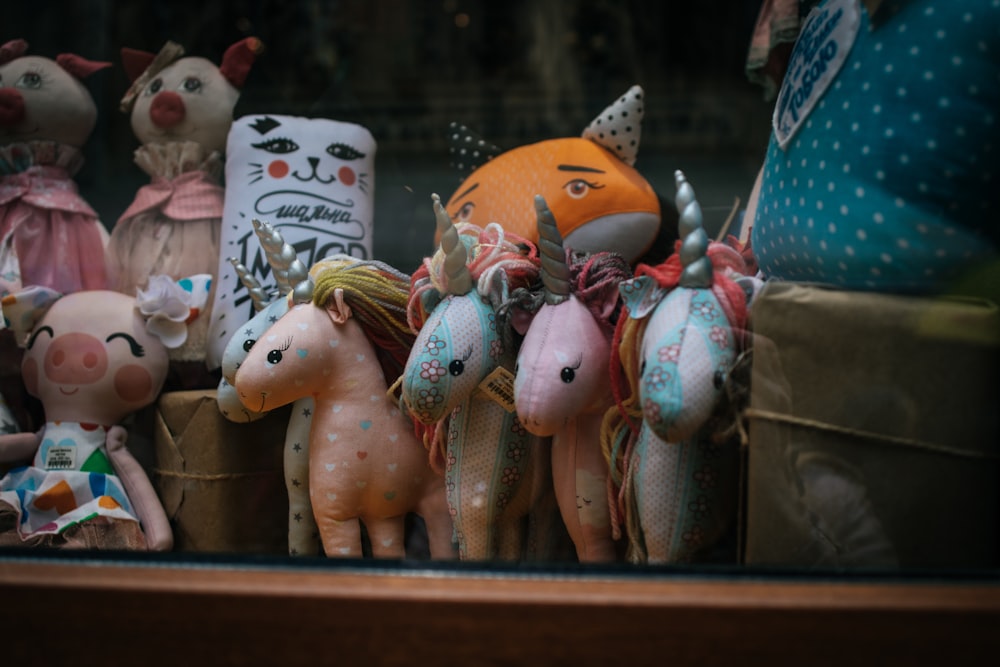 several unicorn plush toys