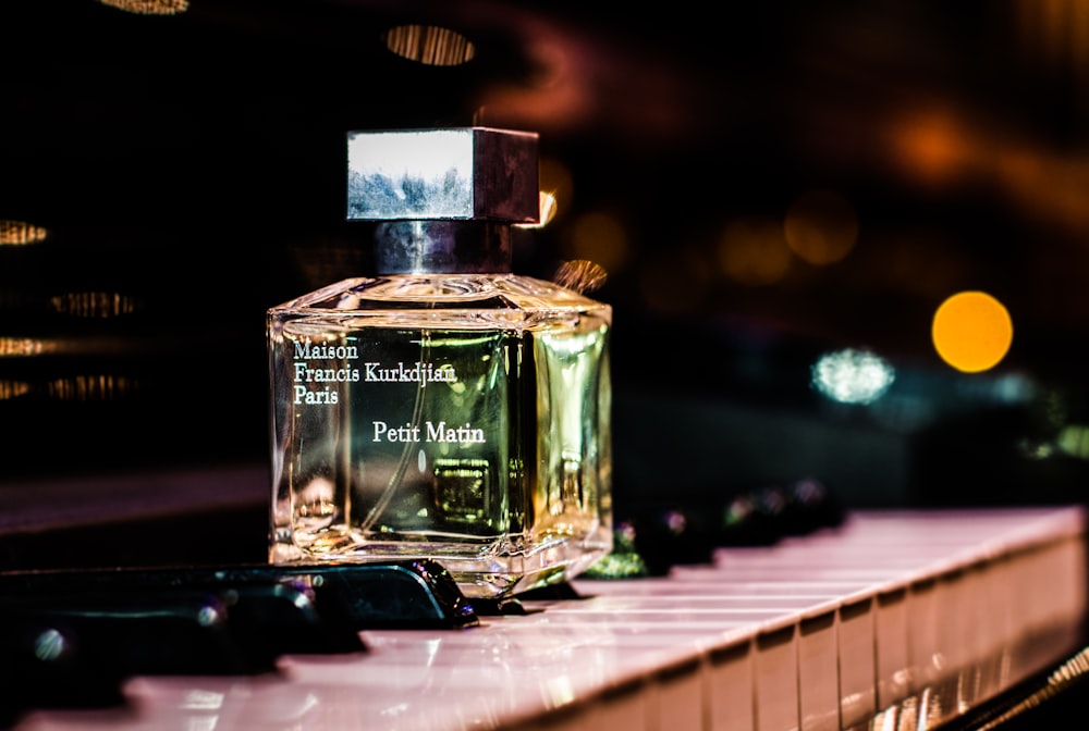 clear fragrance bottle on piano