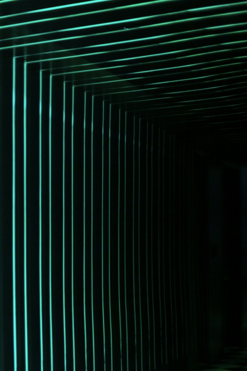 a dark tunnel with green lines going through it