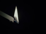 A candle burning softly in a dark room, representing hope and the light of Christ.