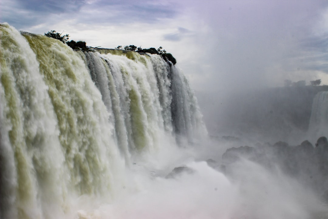 waterfalls under nimbus clouds