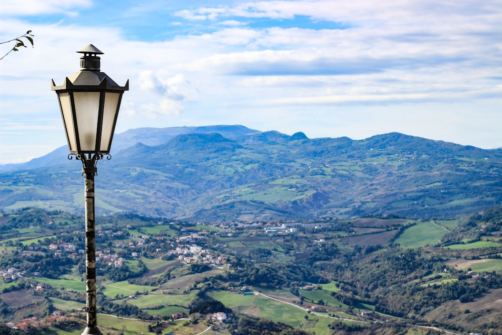 a lamp post on top of a hill overlooking a valley