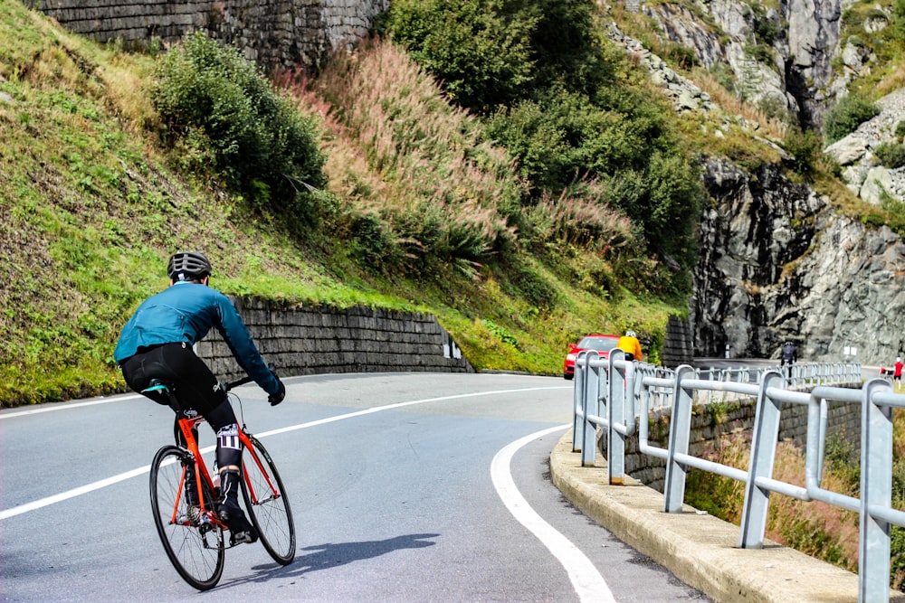 man riding mountain bike in road during daytime