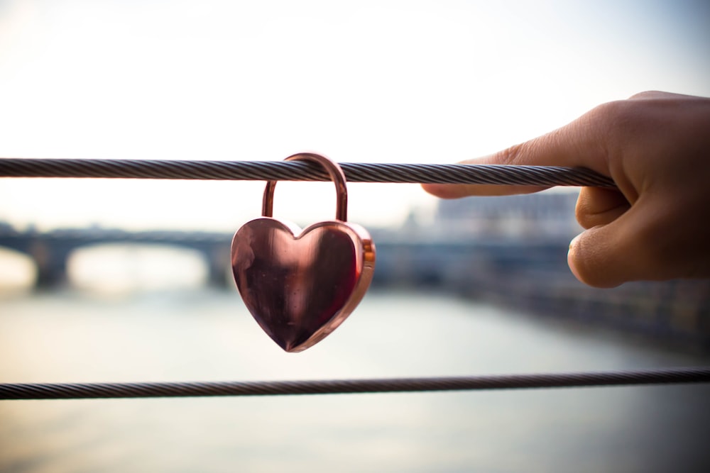 copper heart padlock on cable railings