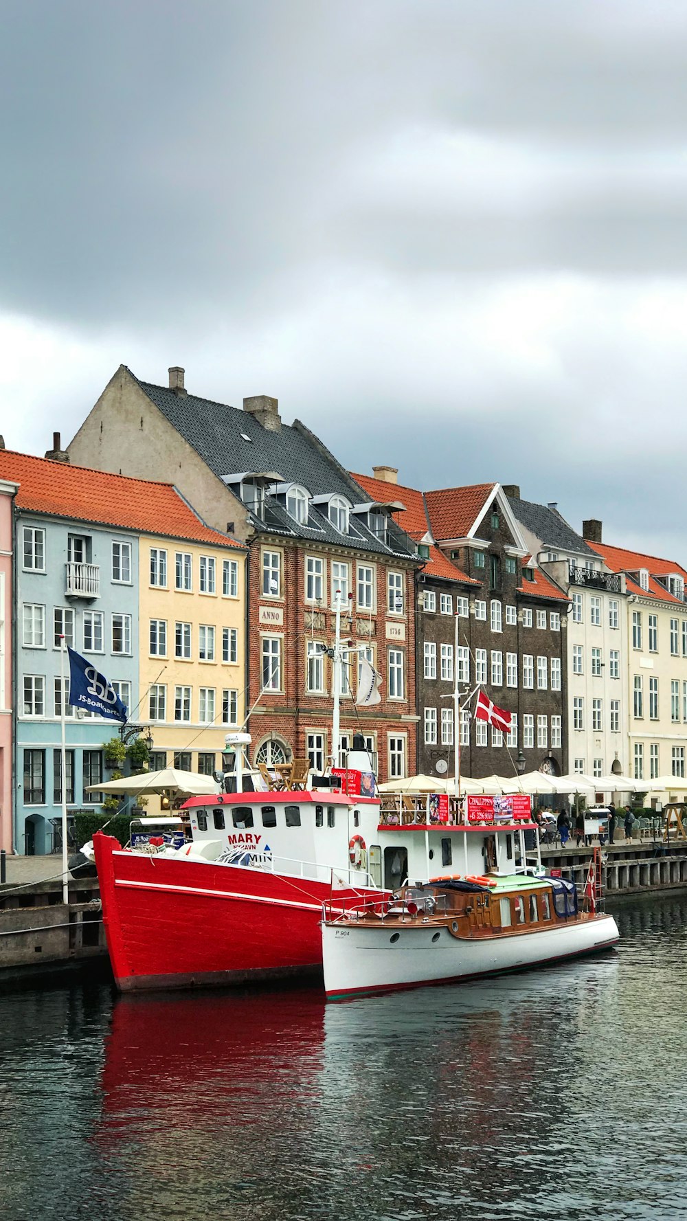 white and red boats near dock