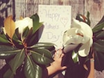 person near happy mother's day signage and plants