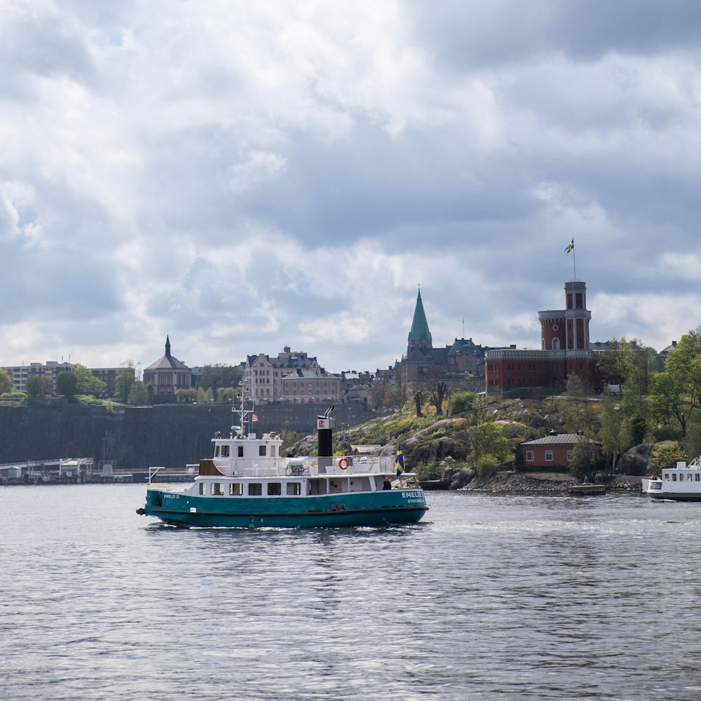 teal and white boat near trees