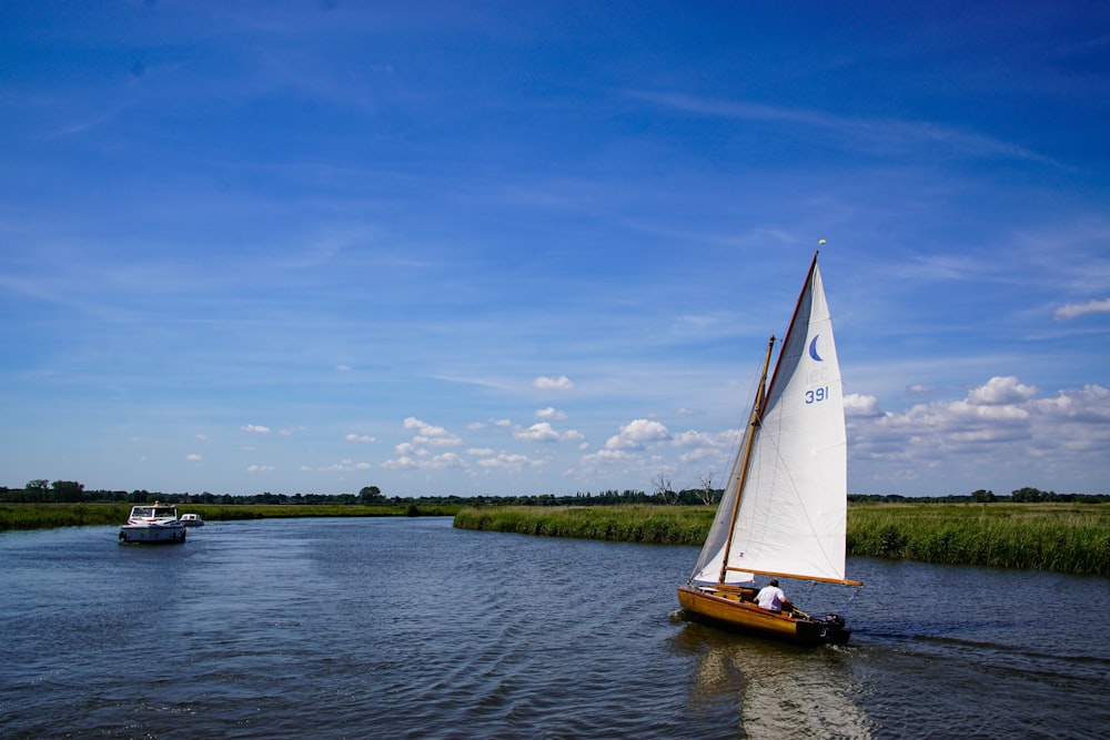 brown and white boat on body of water during daytime