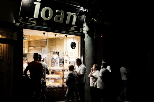 A bustling bakery storefront with customers lining up, showcasing a successful brand launch.