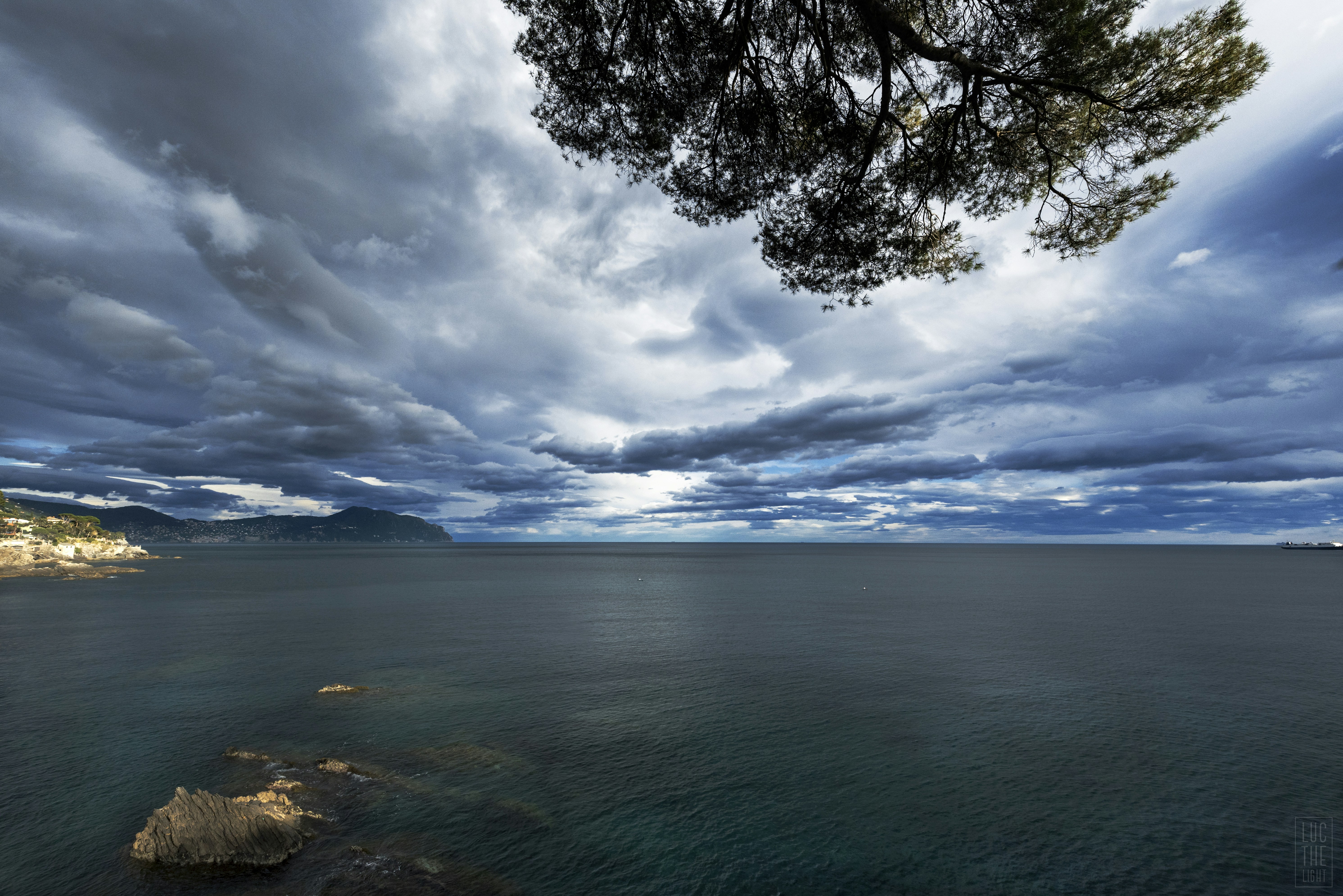 grey and blue cloudy sky over the sea