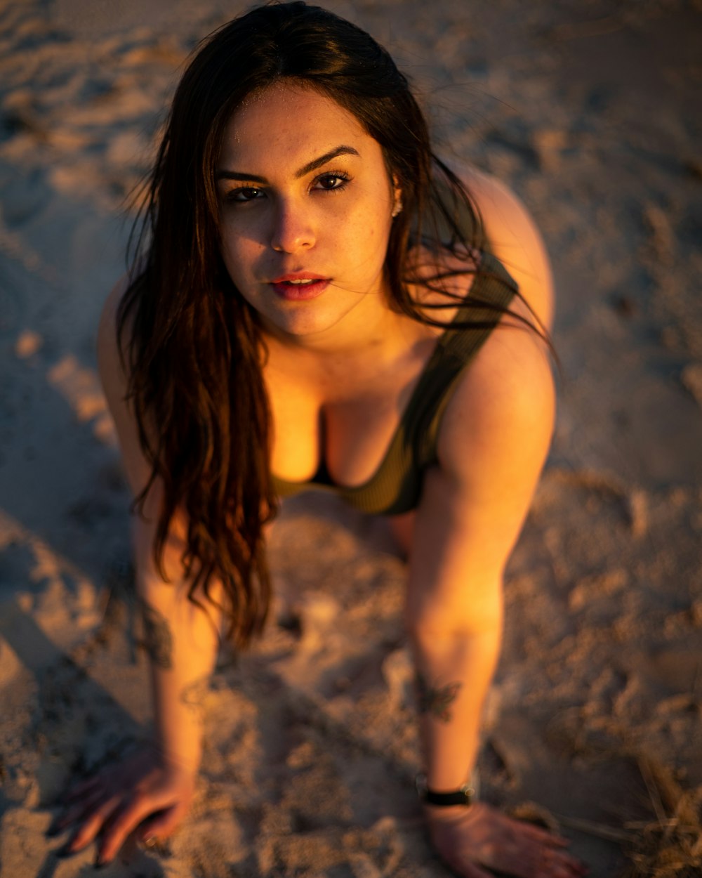 woman wearing tank top on sand