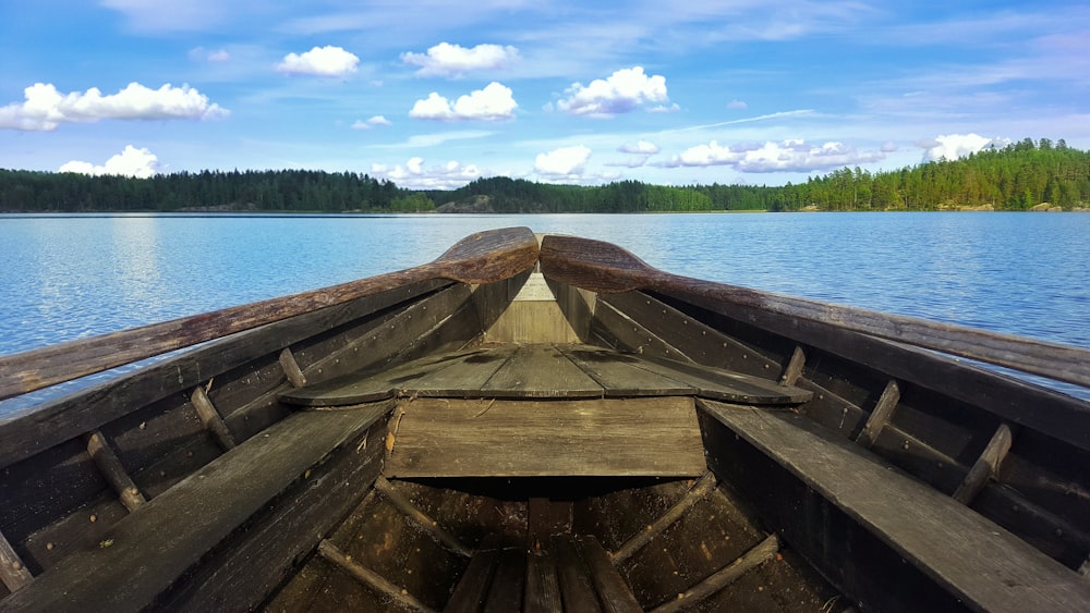 brown boat on body of water